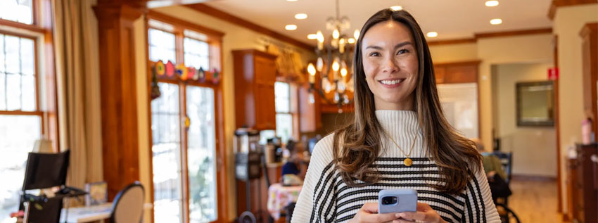 Woman using her phone to pay a bill