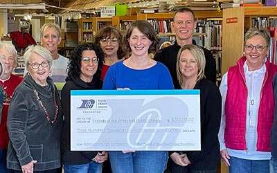 People holding large check for Whitehall Library