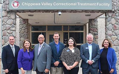Group standing in front of a jail