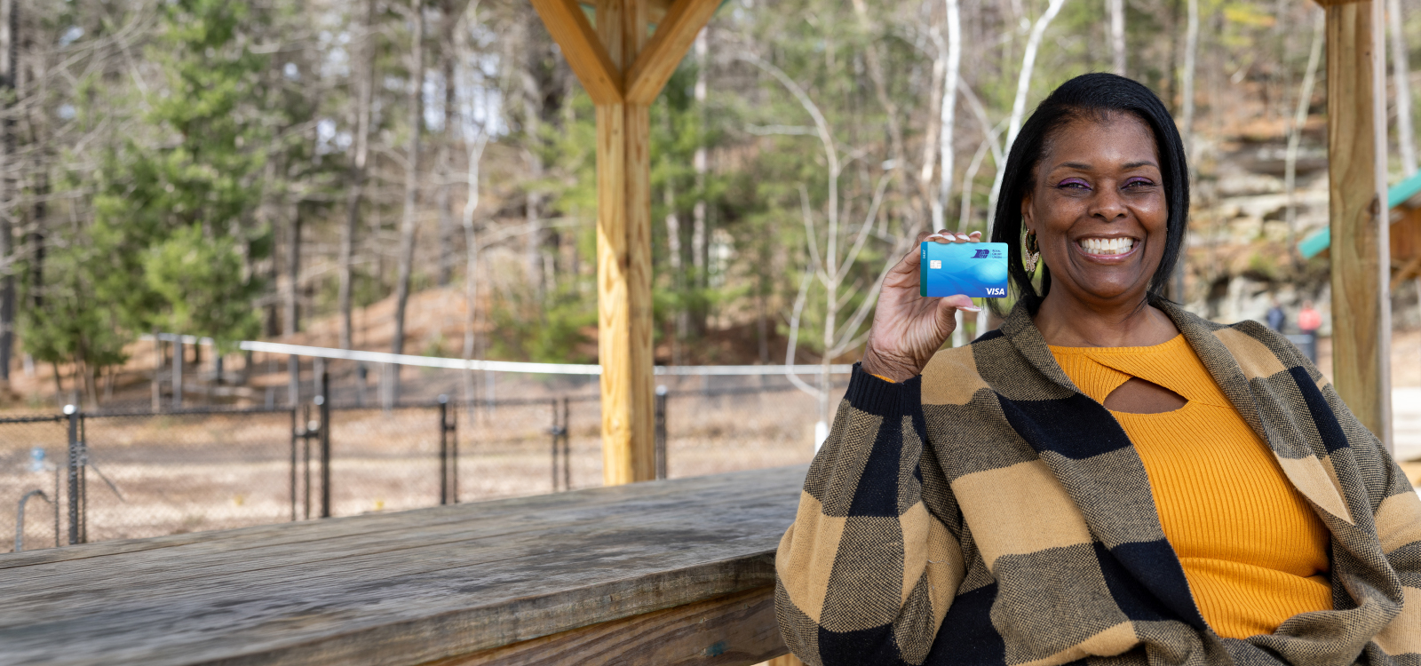 Woman holding a Royal debit card