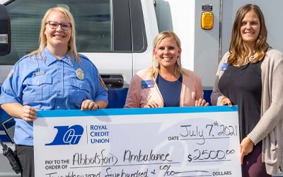 Photo of Members holding a big check