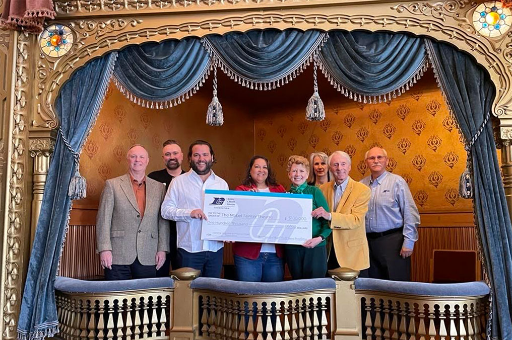 Group of RCU leaders holding a big check