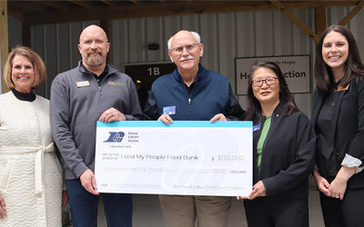 Group of RCU leadership holding a big check