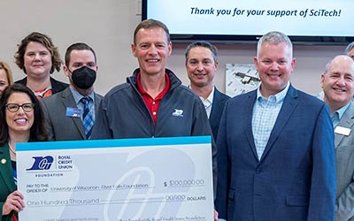 Group of people holding a big check at UWRF