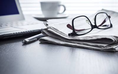 Pair of glasses on a newspaper