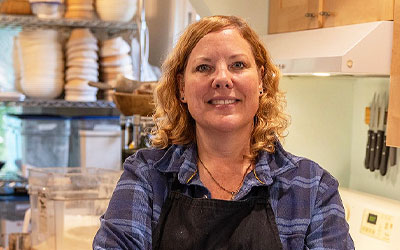 Business Member standing in her shop