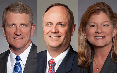 Photo of three board members