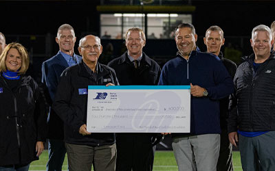 Group of leaders holding a large check