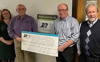 Group of Royal Leadership and Dove Healthcare leadership holding a big check