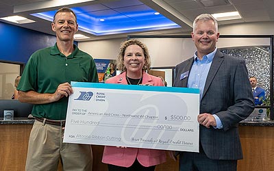 Group of people holding large check