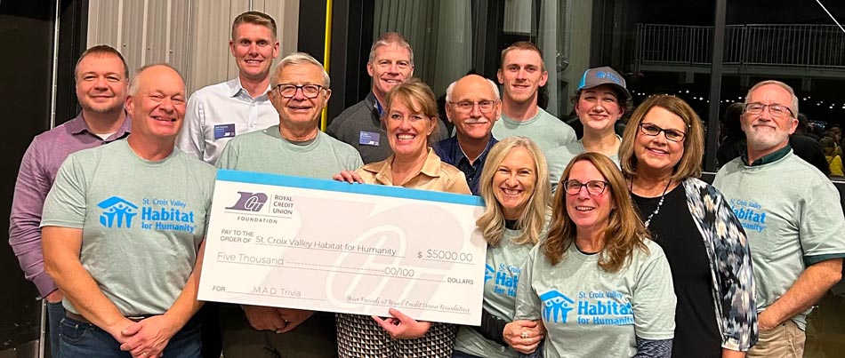 Photo of people holding a big check at the M.A.D. Trivia event