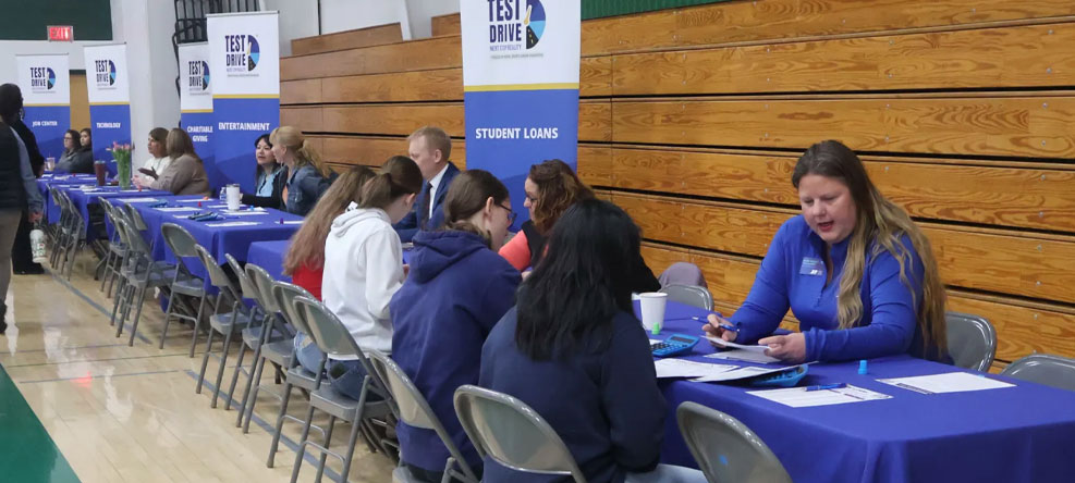 Students working with financial person at a Test Drive event