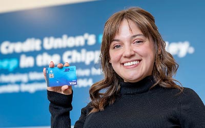 Royal Credit Union Member holding a debit card