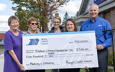 Team Members holding a check for Medford library