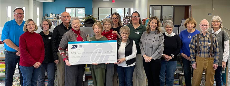 Group of people holding a large check at the Ellsworth Library