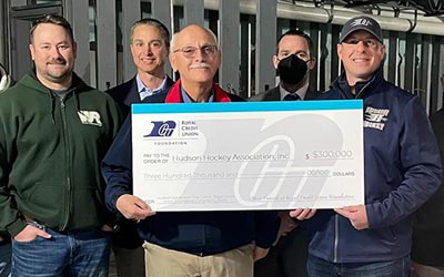 Photo of RCU foundation team and community folks holding a check