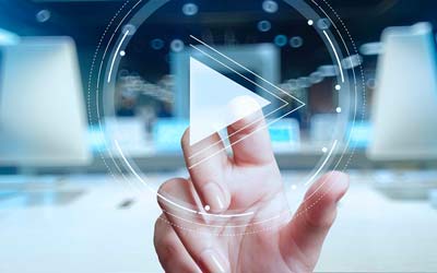 Person's hand clicking on a play button