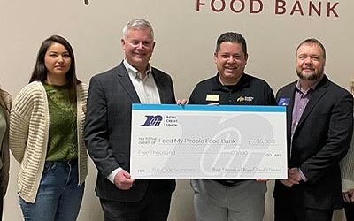 Photo of group of people holding a large check for $5000