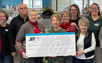 Group of people holding a large check at the Ellsworth Library