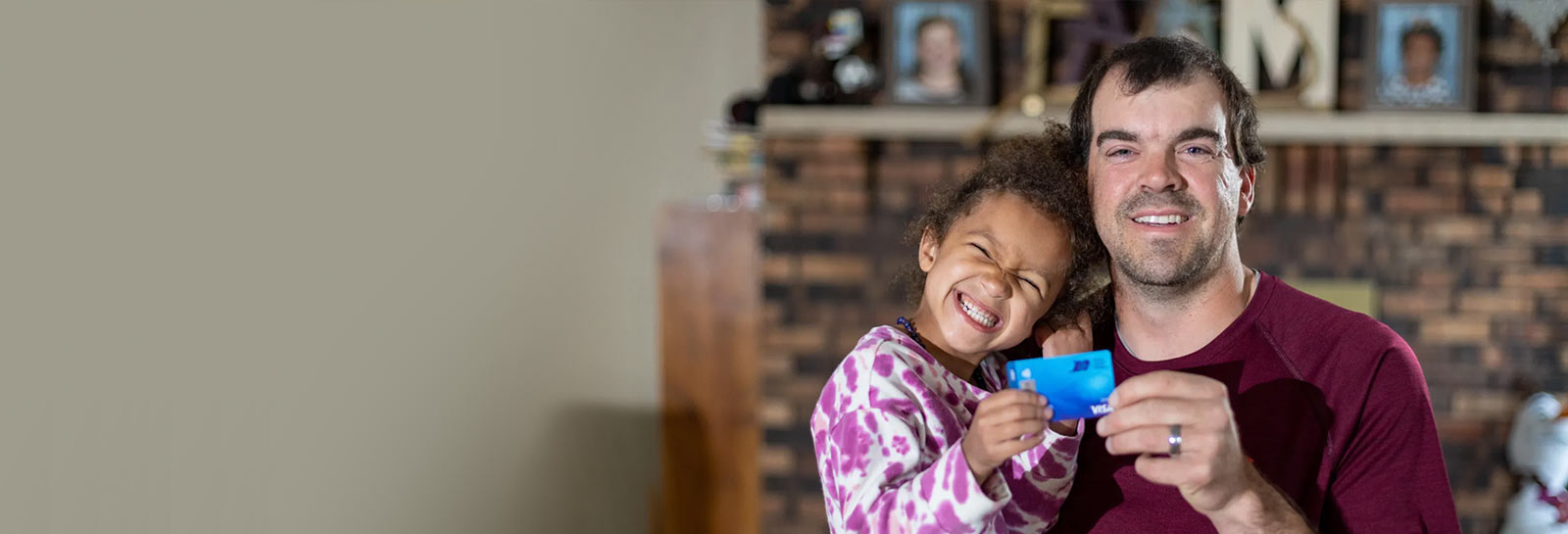 RCU Member with daughter holding a debit cardi
