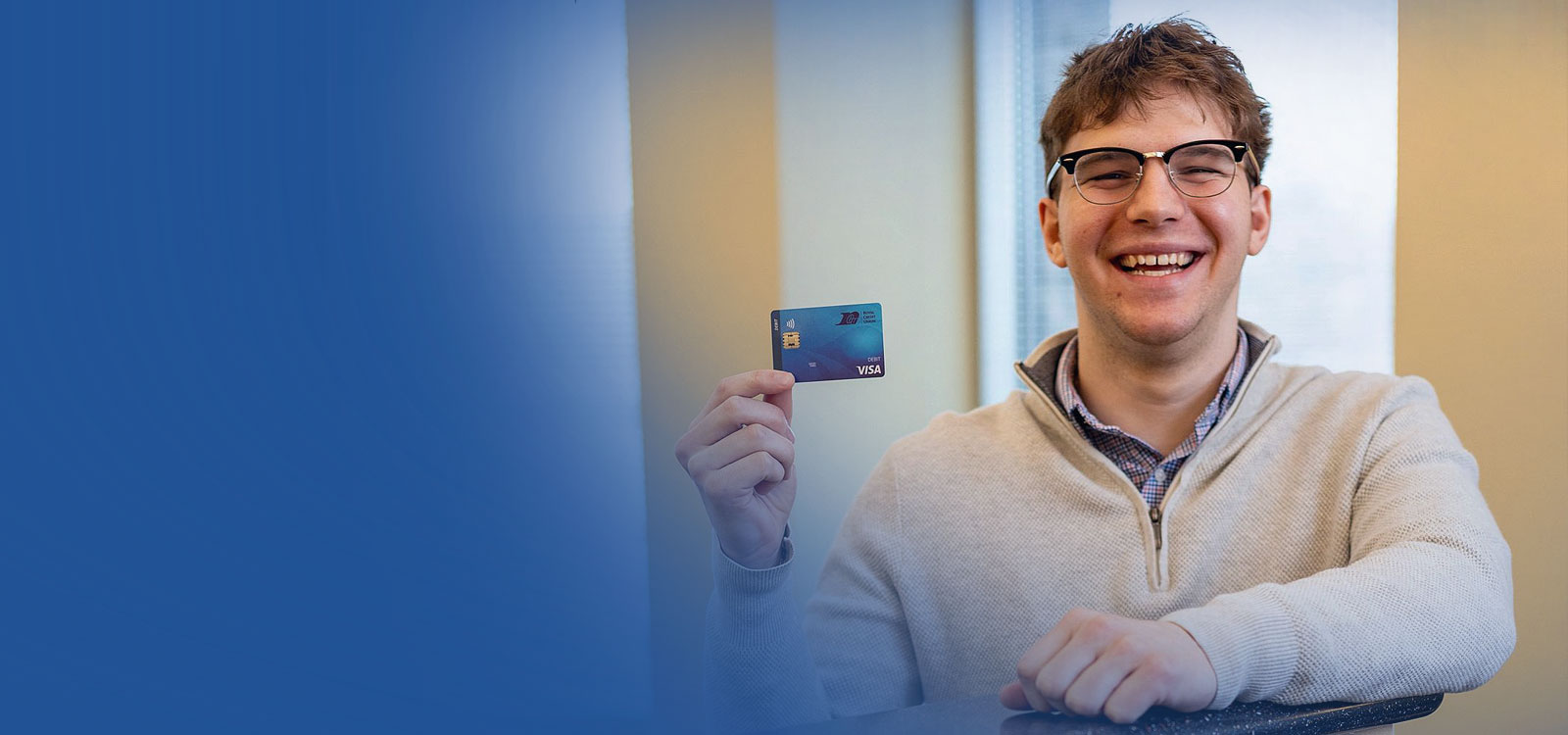 Royal Member holding a debit card