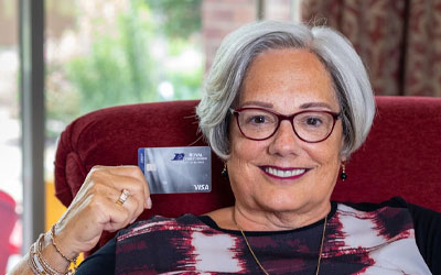 Royal Member holding a credit card