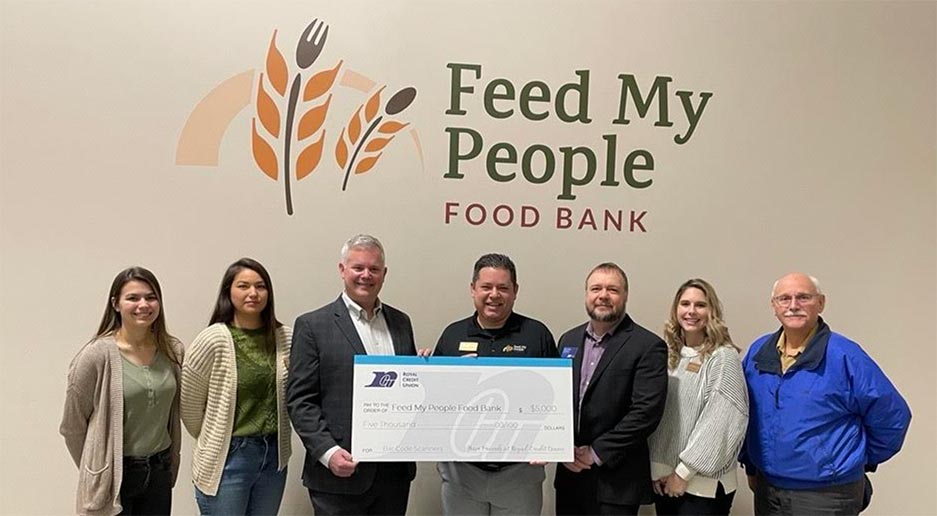 Photo of group of people holding a large check for $5000