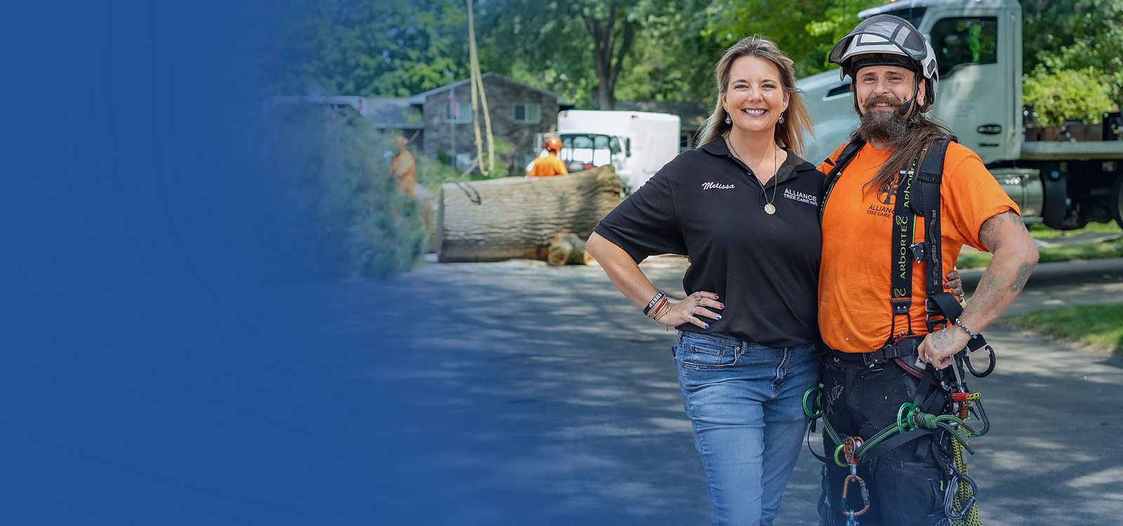 Royal business owner standing with her coworker in a tree service setting