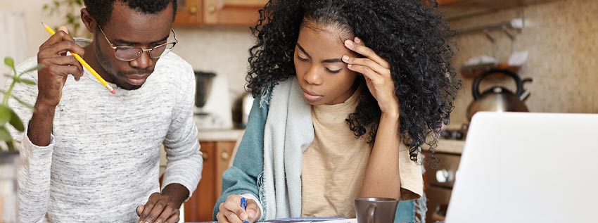 Two people working together to solve financial problems
