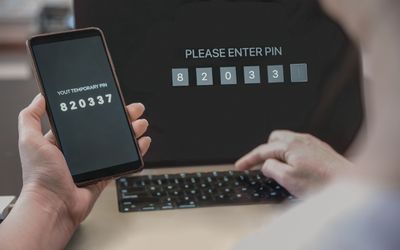 photo of a laptop and phone with secure icon