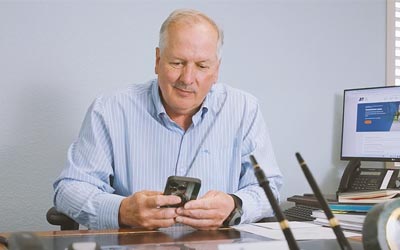 RCU Member working on his cell phone and his Sweep Account