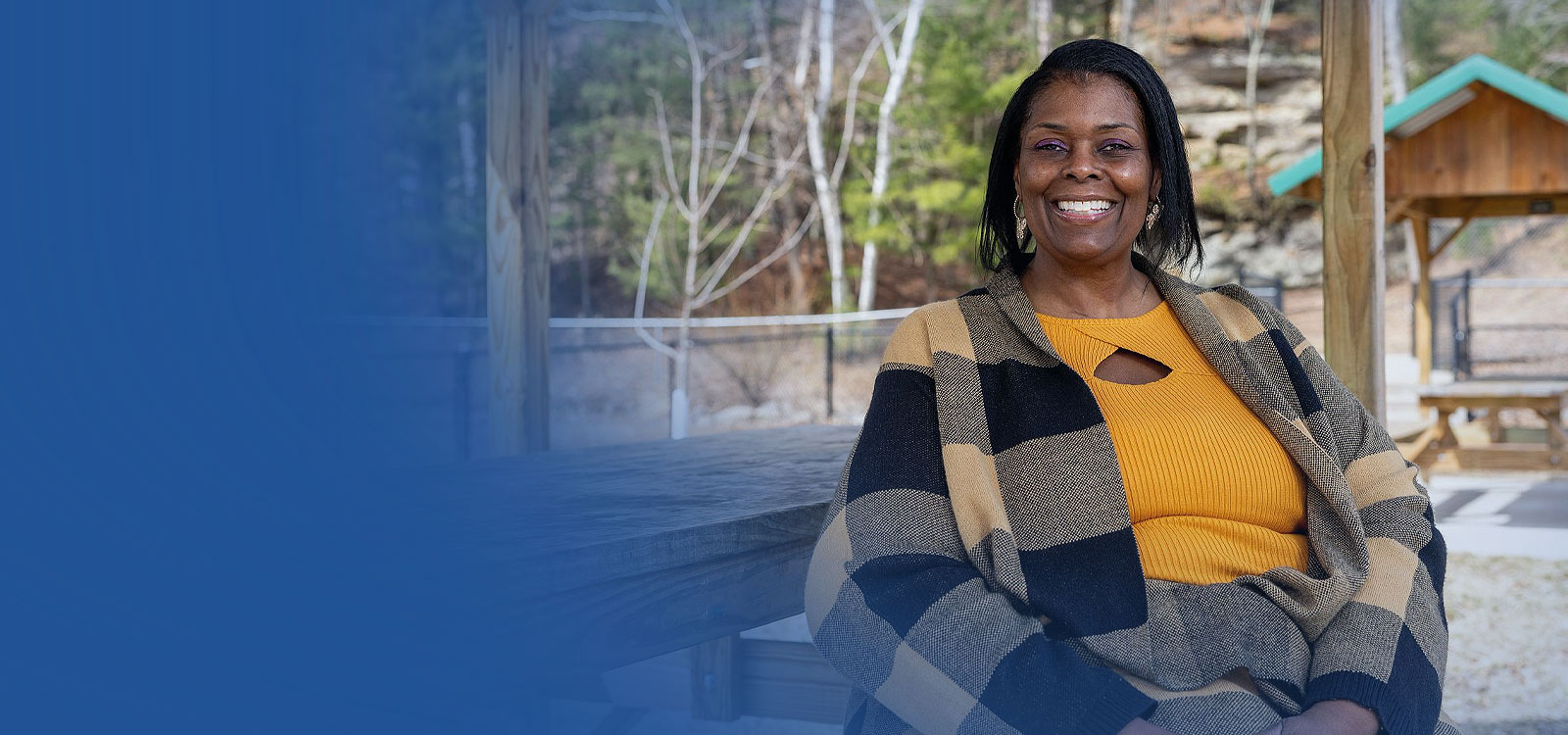 Royal Member sitting in a park smiling