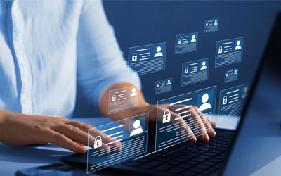 Person on a laptop with icons floating over the image