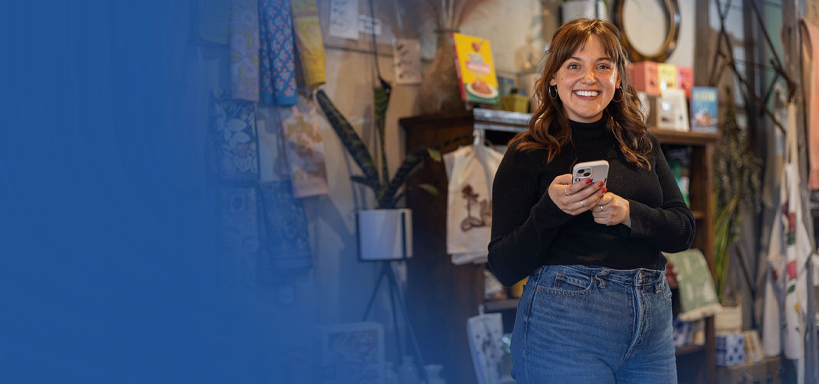 Young woman on her cell phone in a store accessing Kwik Cash