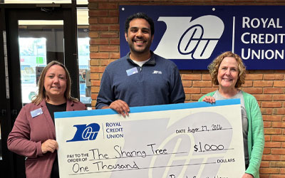 Group of Royal leaders holding a big check for $1,000