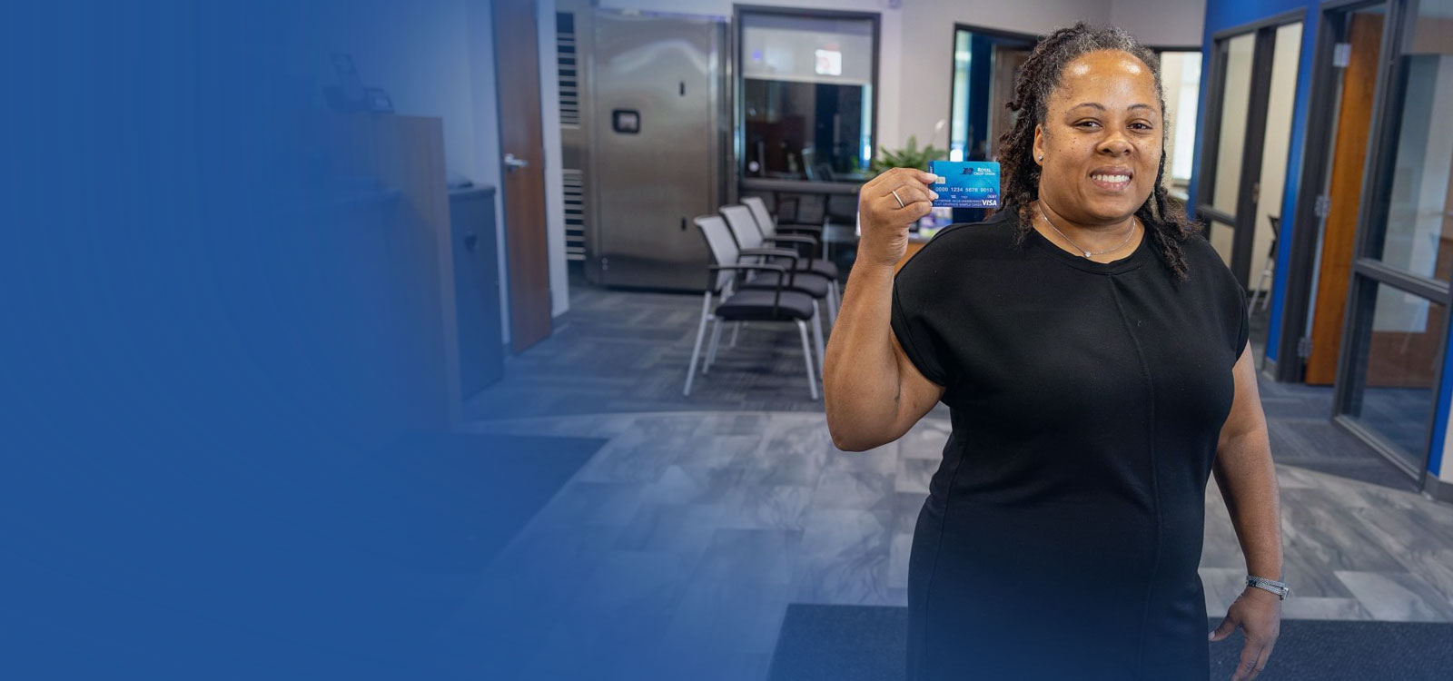 Happy woman holding RCU debit card