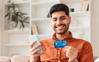 Royal Member holding a Debit Card