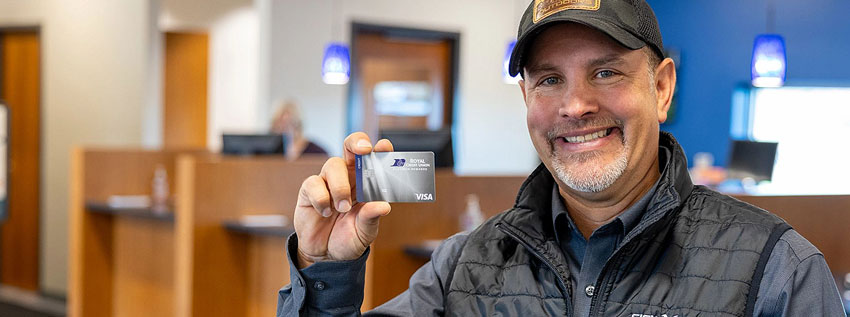 RCU Member holding a Royal Rewards Visa card