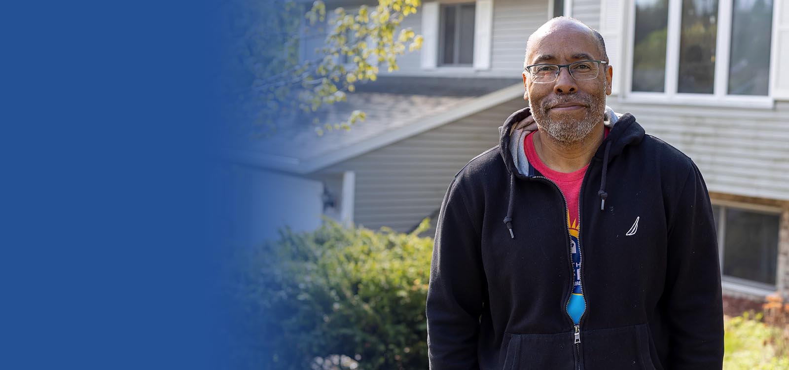 Man standing in front of his house