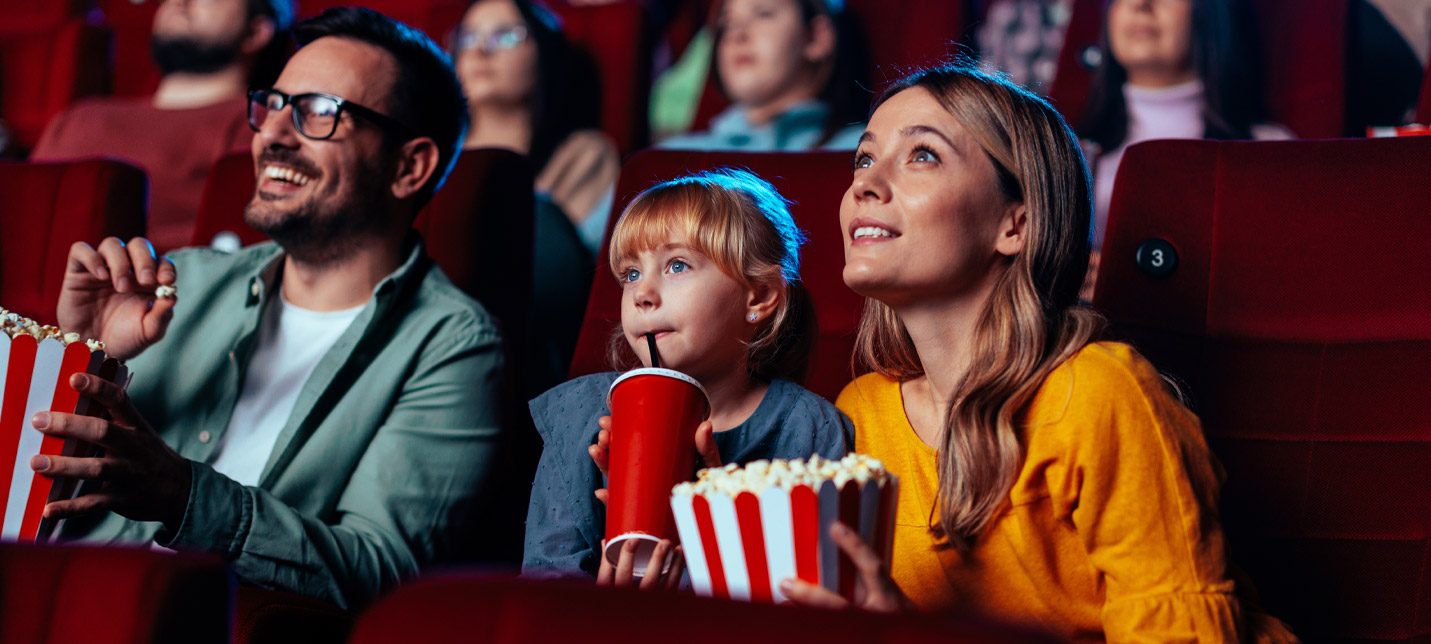 Family at a cinema with popcorn
