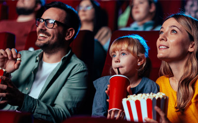 Family at a cinema with popcorn