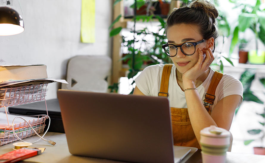Young Woman learning about Enrich on her laptop