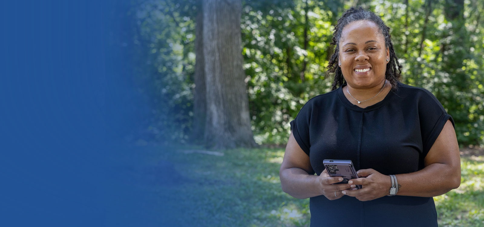 Woman standing in front of her house