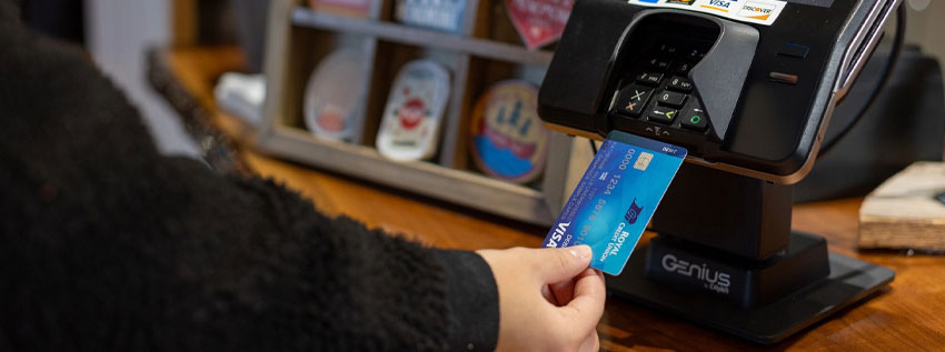 Person swiping their debit card