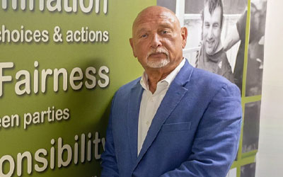 Business man standing in front of non profit sign