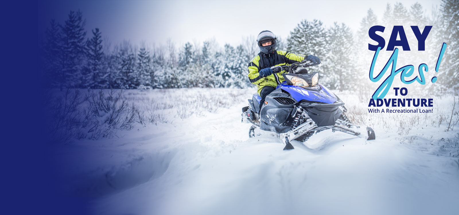 Young man in the snow on a snowmobile