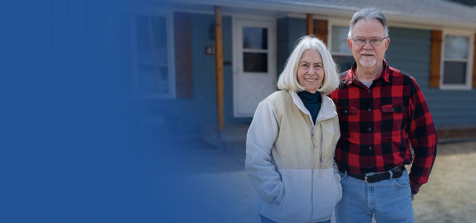 Husband and wife standing in the front yard