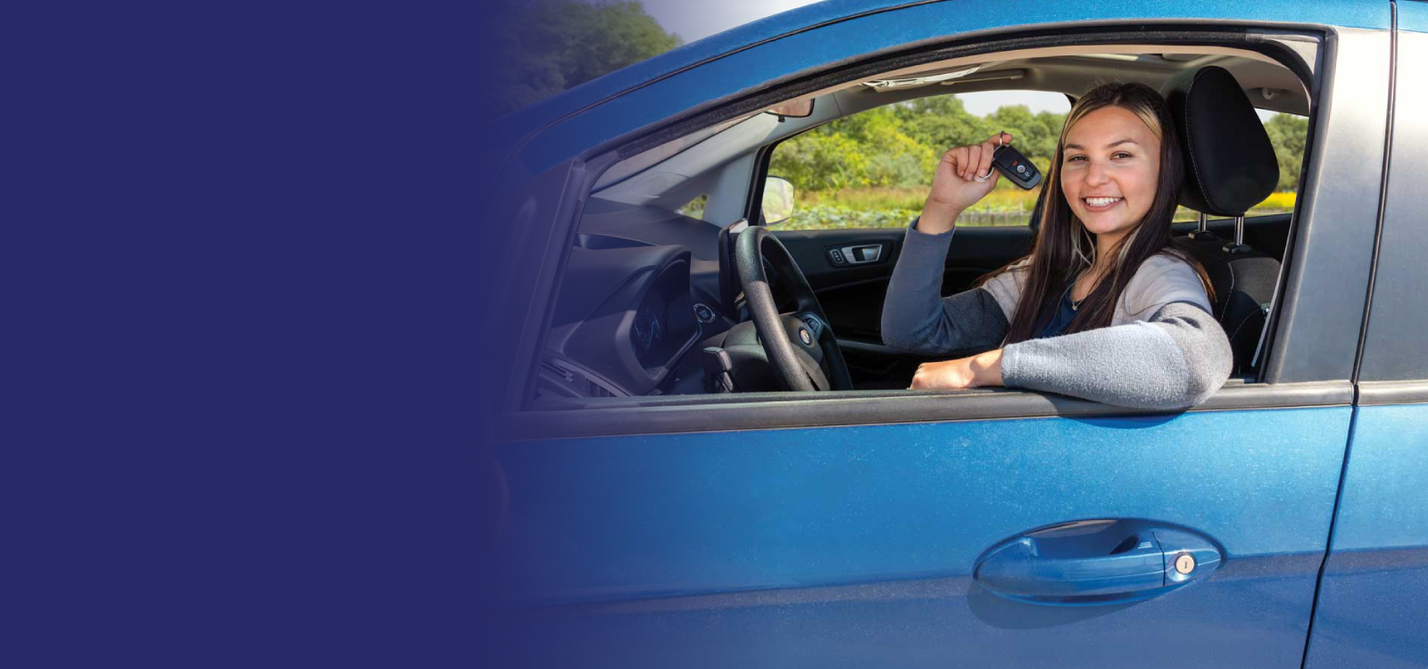 Woman sitting in her car holding keys