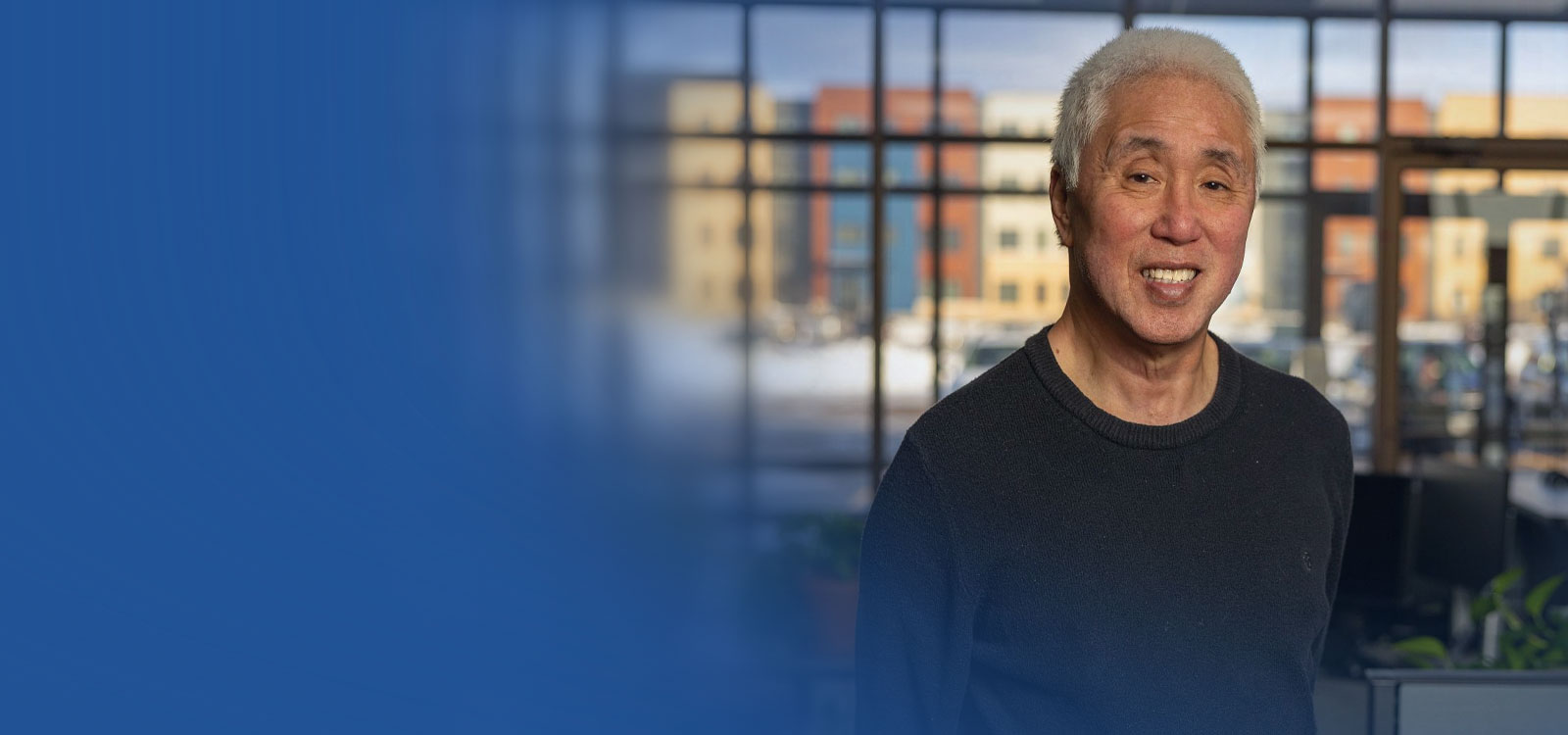 Man standing in an office smiling