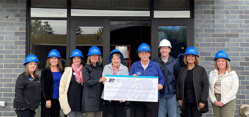 Photo of community leaders holding a big check